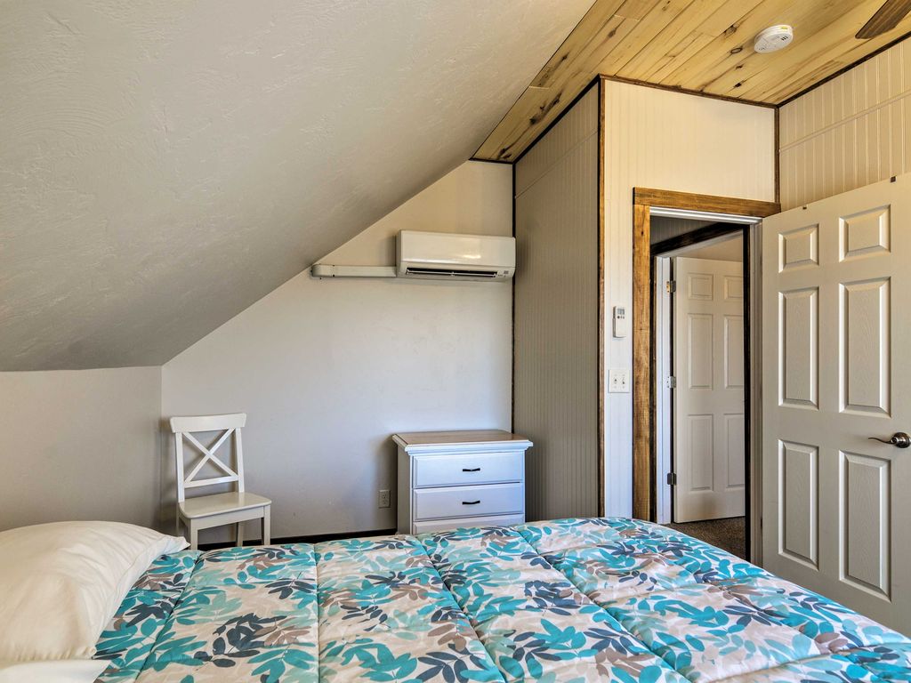 The second bedroom at Sunrise Hollow feature a comfy queen bed, knotty aspen lined ceiling, a ceiling fan, and private climate control.